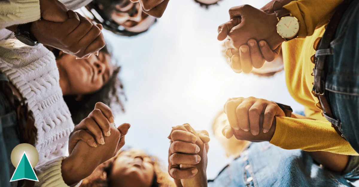 Group of friends holding hands in a circle