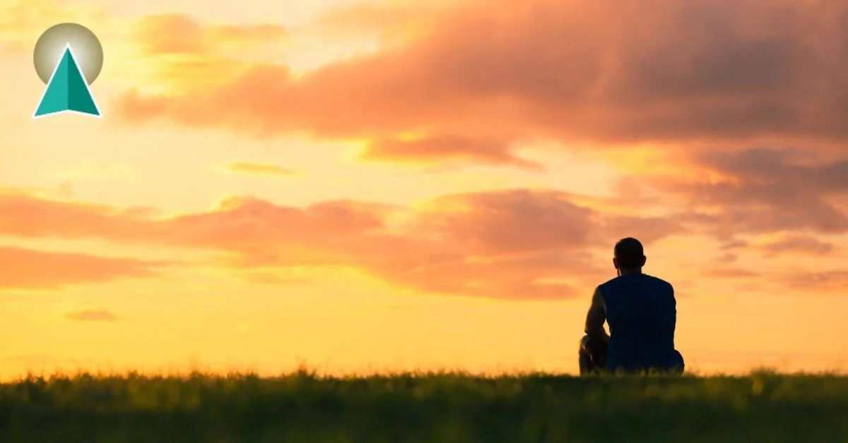 Man in the distance watching the sunset
