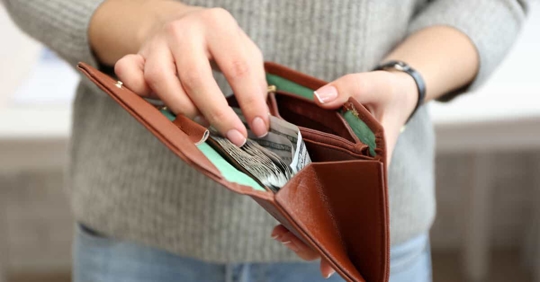 Person looking at their wallet