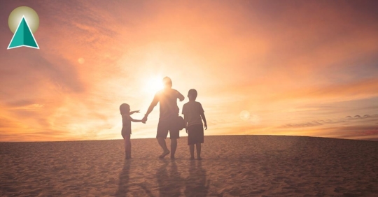 Man with children looking at the sunset