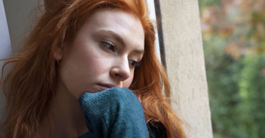 Woman looking longingly out the window