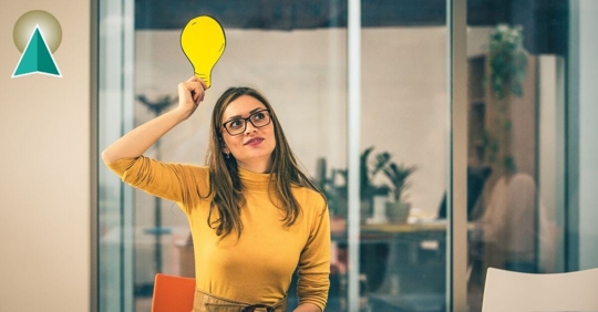 Woman holding a cartoon lightbulb over her head