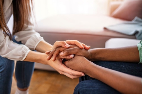 patient and therapist grabbing each others hands