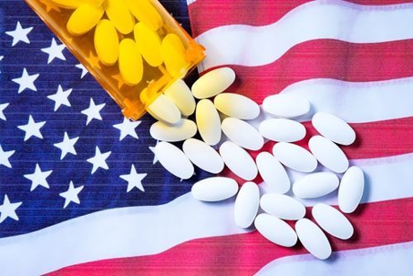 spilled bottle of pills over the american flag
