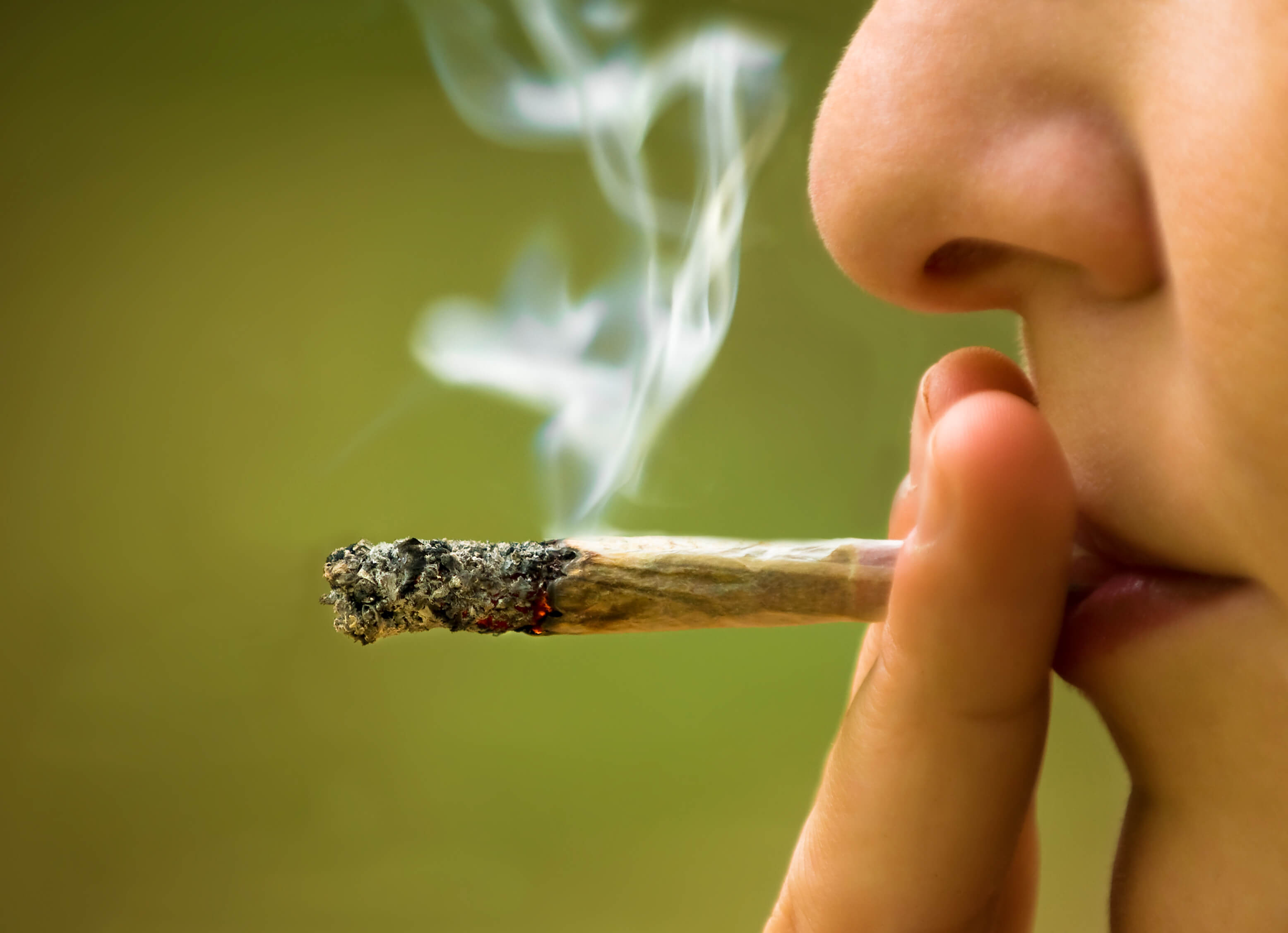 closeup photo of a person smoking a marijuana cigarette | Arizona marijuana rehab