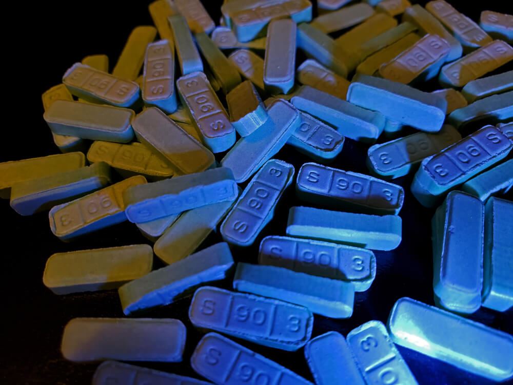 pile of xanax pills on a black background